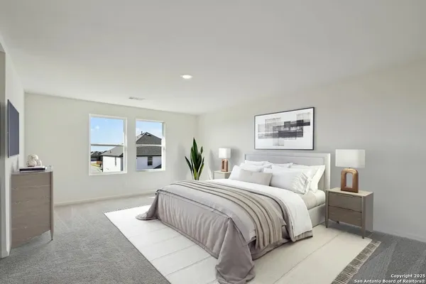 a bedroom with a large bed and a couch