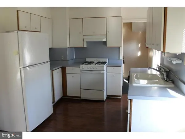 a kitchen with stainless steel appliances granite countertop a refrigerator a stove a sink and a microwave