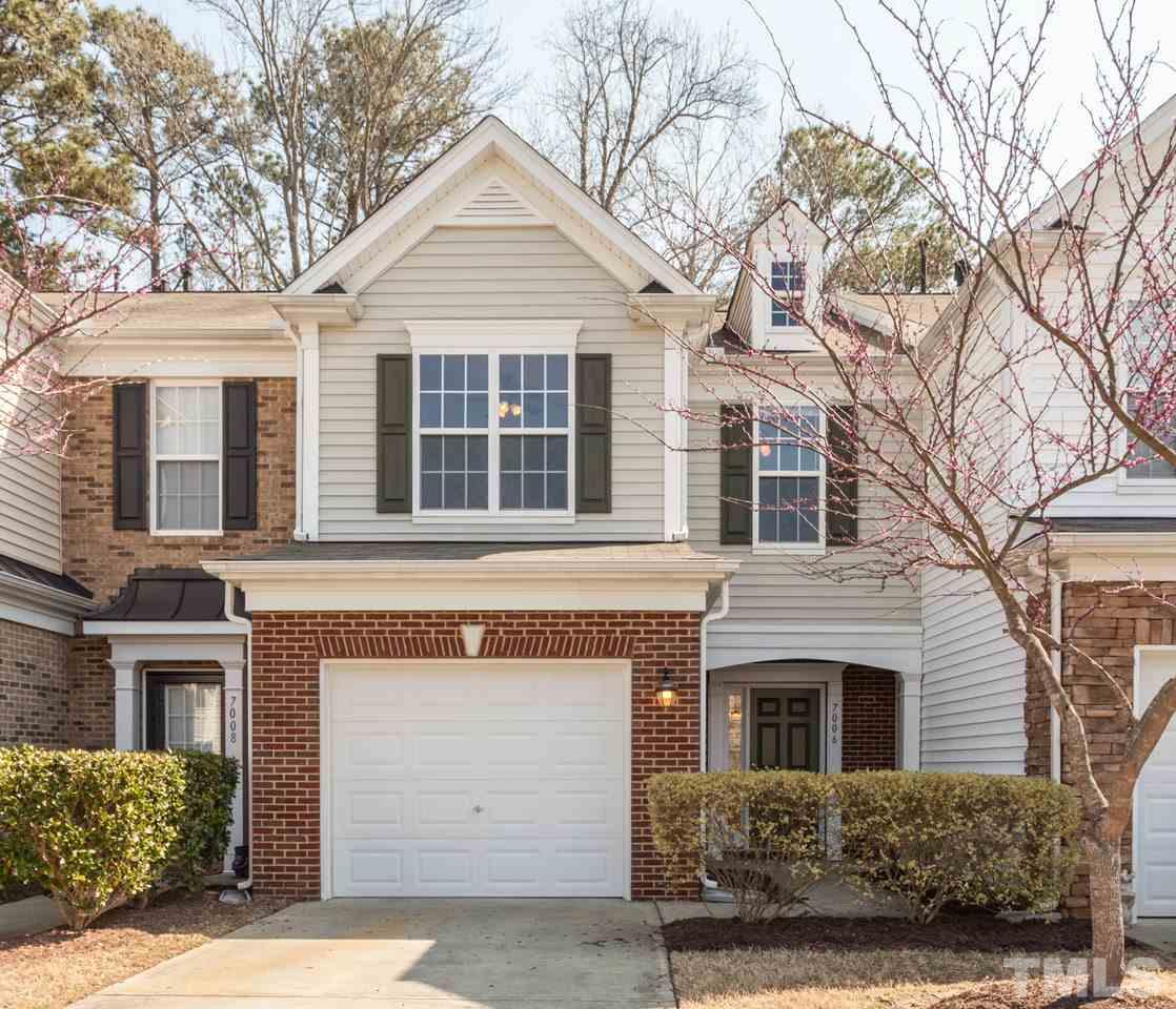 7006 Racine Way Raleigh, NC 27690 - Photo 1 of 24 a front view of a house with a yard and garage