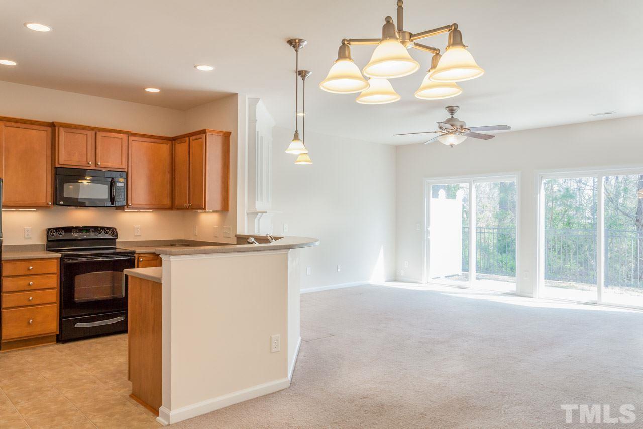 7006 Racine Way Raleigh, NC 27690 - Photo 2 of 24 a kitchen with stainless steel appliances granite countertop a stove a sink and a refrigerator