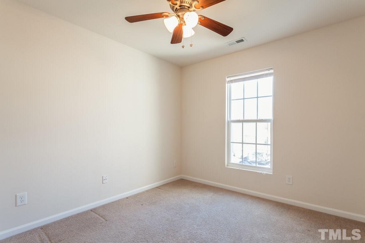 7006 Racine Way Raleigh, NC 27690 - Photo 11 of 24 an empty room with a window and a fan