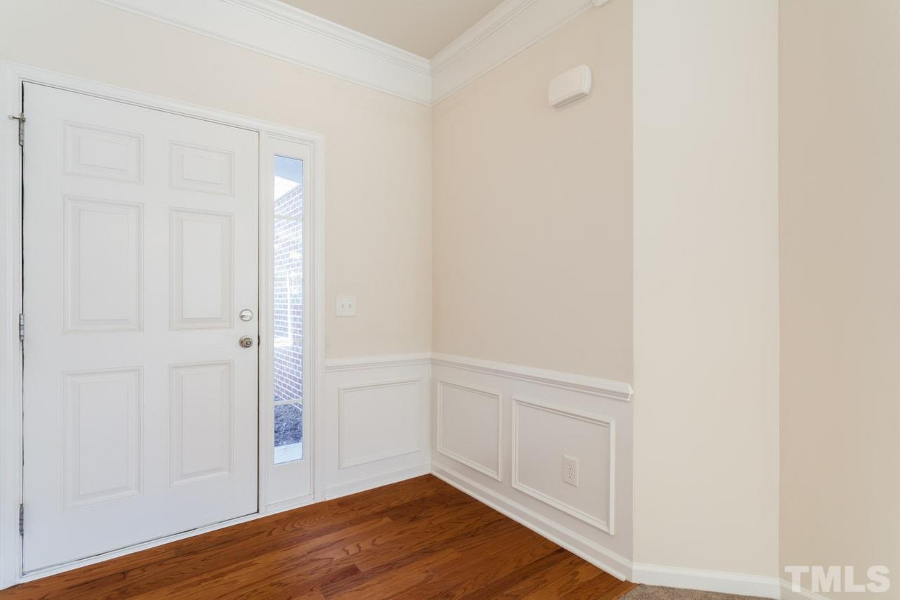 7006 Racine Way Raleigh, NC 27690 - Photo 17 of 24 a view of an empty room with wooden floor