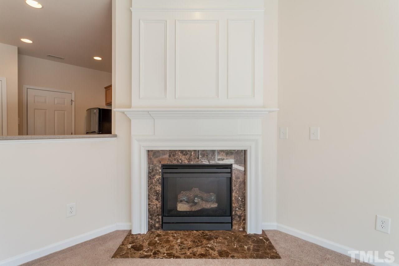 7006 Racine Way Raleigh, NC 27690 - Photo 22 of 24 a living room with furniture and a fireplace