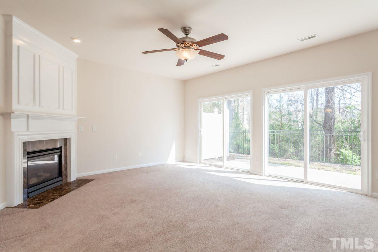 7006 Racine Way Raleigh, NC 27690 - Photo 4 of 24 a view of an empty room with a fireplace and a window