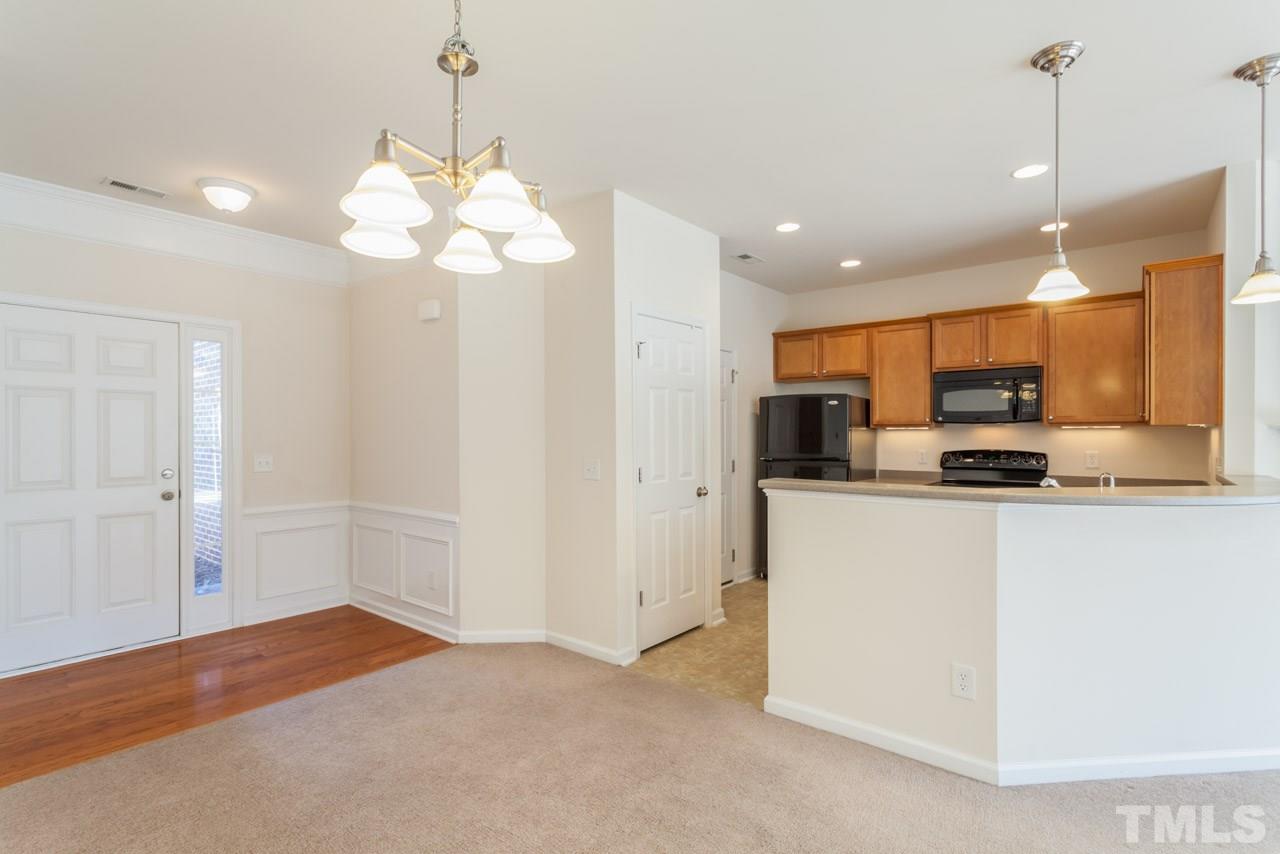 7006 Racine Way Raleigh, NC 27690 - Photo 5 of 24 a view of a kitchen with a sink and a chandelier