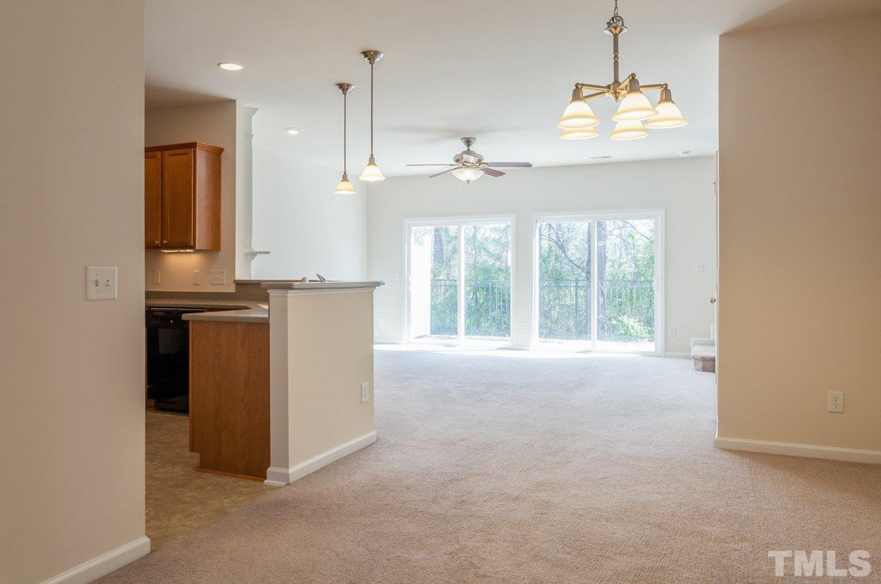 7006 Racine Way Raleigh, NC 27690 - Photo 6 of 24 a view of an empty room with kitchen view and a window