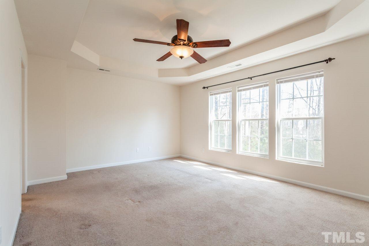 7006 Racine Way Raleigh, NC 27690 - Photo 8 of 24 an empty room with windows and ceiling fan