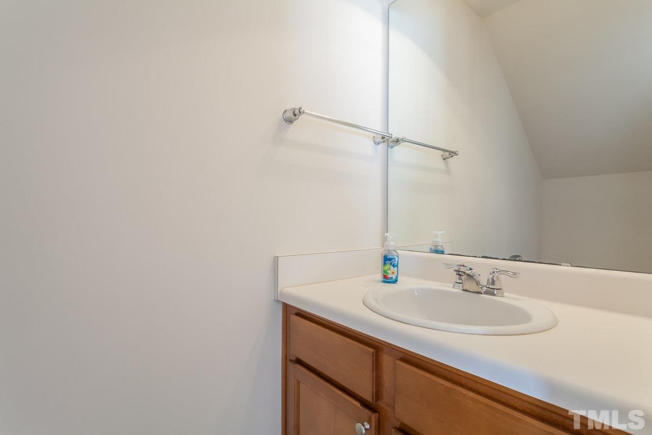 7006 Racine Way Raleigh, NC 27690 - Photo 9 of 24 a bathroom with a sink and a mirror