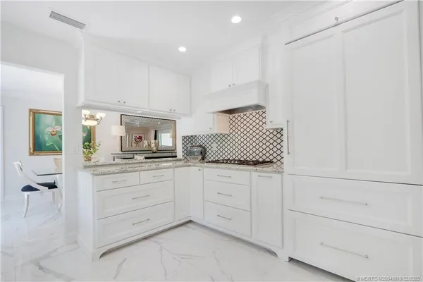 a kitchen with white cabinets and a stove
