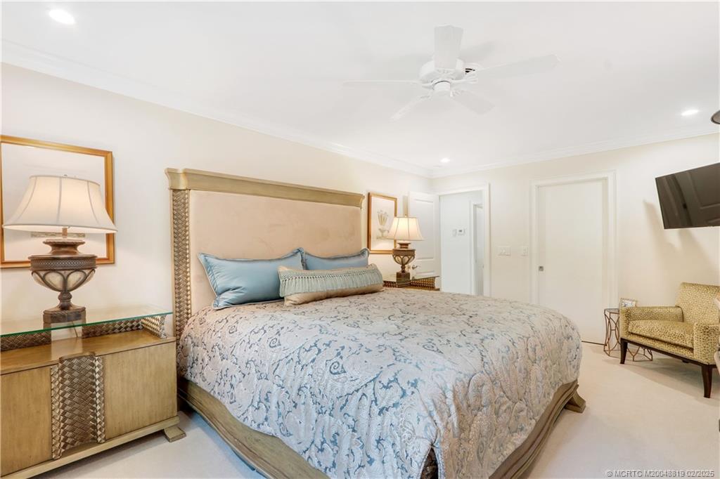 24 Emarita Way Sewall's Point, FL 34996 - Photo 17 of 26 a bedroom with a bed and a flat screen tv