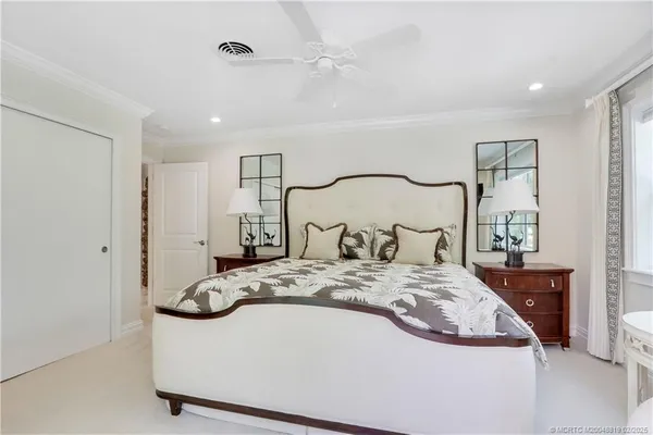 a bedroom with a large bed and a couch