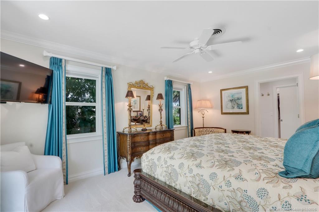 24 Emarita Way Sewall's Point, FL 34996 - Photo 21 of 26 a bedroom with a large bed and a couch