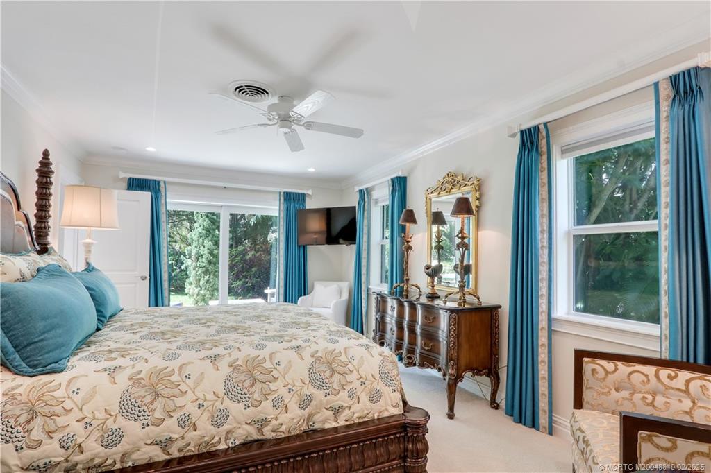 24 Emarita Way Sewall's Point, FL 34996 - Photo 22 of 26 a bed sitting in a bedroom next to a window