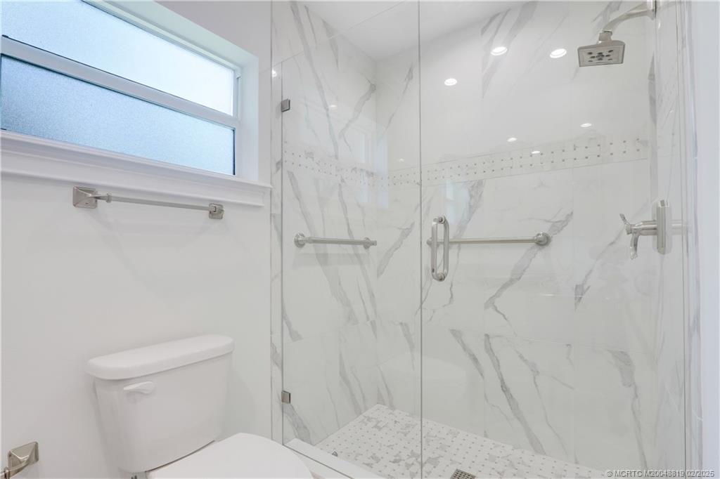 24 Emarita Way Sewall's Point, FL 34996 - Photo 24 of 26 a bathroom with a shower and a toilet