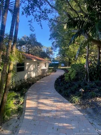 a view of a house with backyard space and sitting area