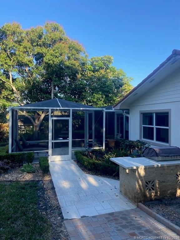 24 Emarita Way Sewall's Point, FL 34996 - Photo 26 of 26 a view of a house with backyard space and sitting area