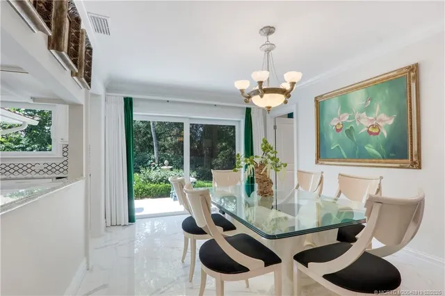 a view of a dining room with furniture and chandelier