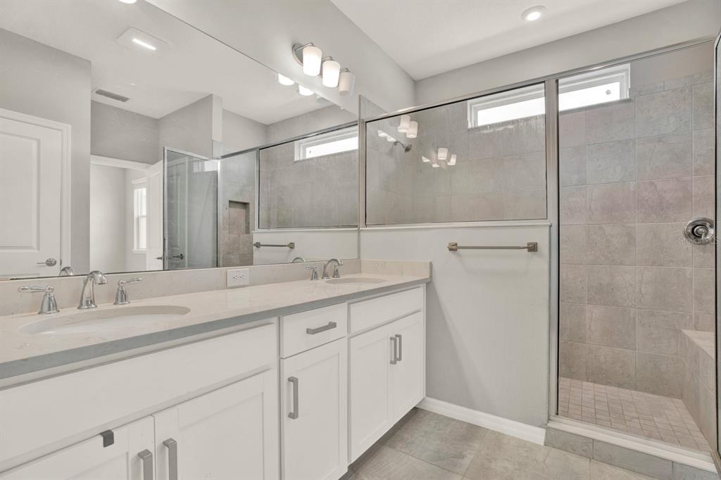 13729 Rangeland Boulevard Odessa, FL 33556 - Photo 20 of 30 a bathroom with a double vanity sink mirror and shower