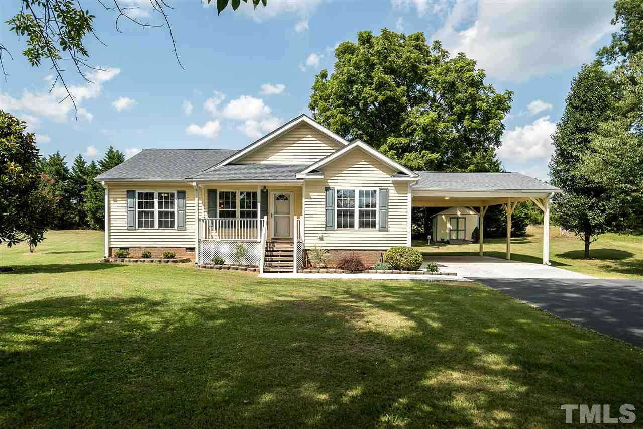 6008 East Pool Road Rougemont, NC 27572 - Photo 1 of 25 a front view of a house with a garden