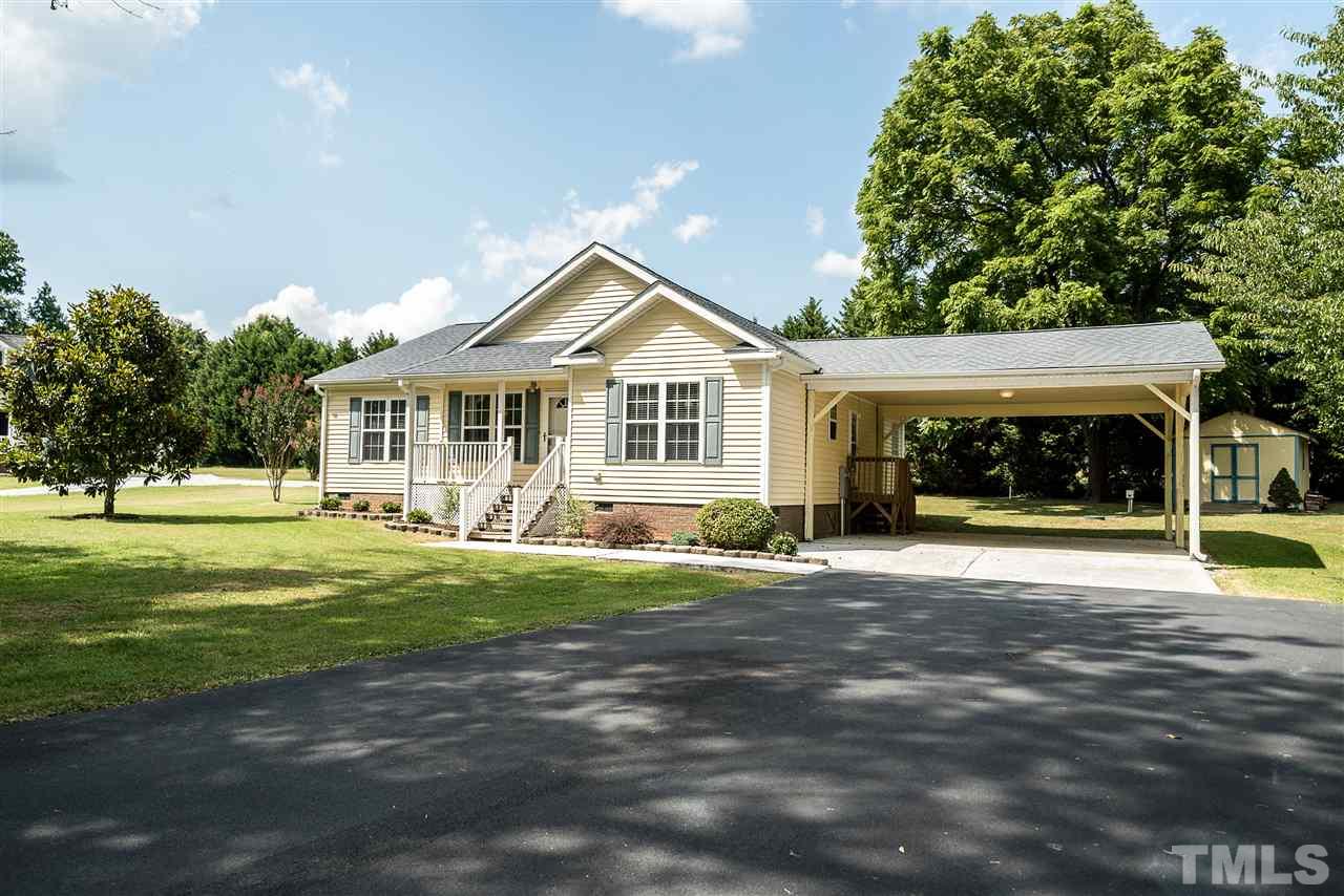 6008 East Pool Road Rougemont, NC 27572 - Photo 2 of 25 a front view of a house with a garden