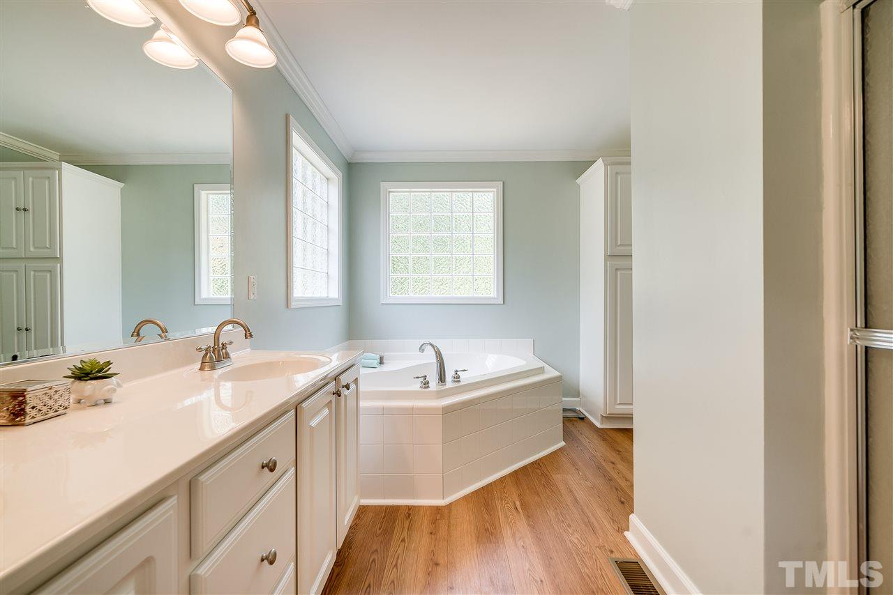 6008 East Pool Road Rougemont, NC 27572 - Photo 13 of 25 a bathroom with a sink double vanity mirror and bathtub