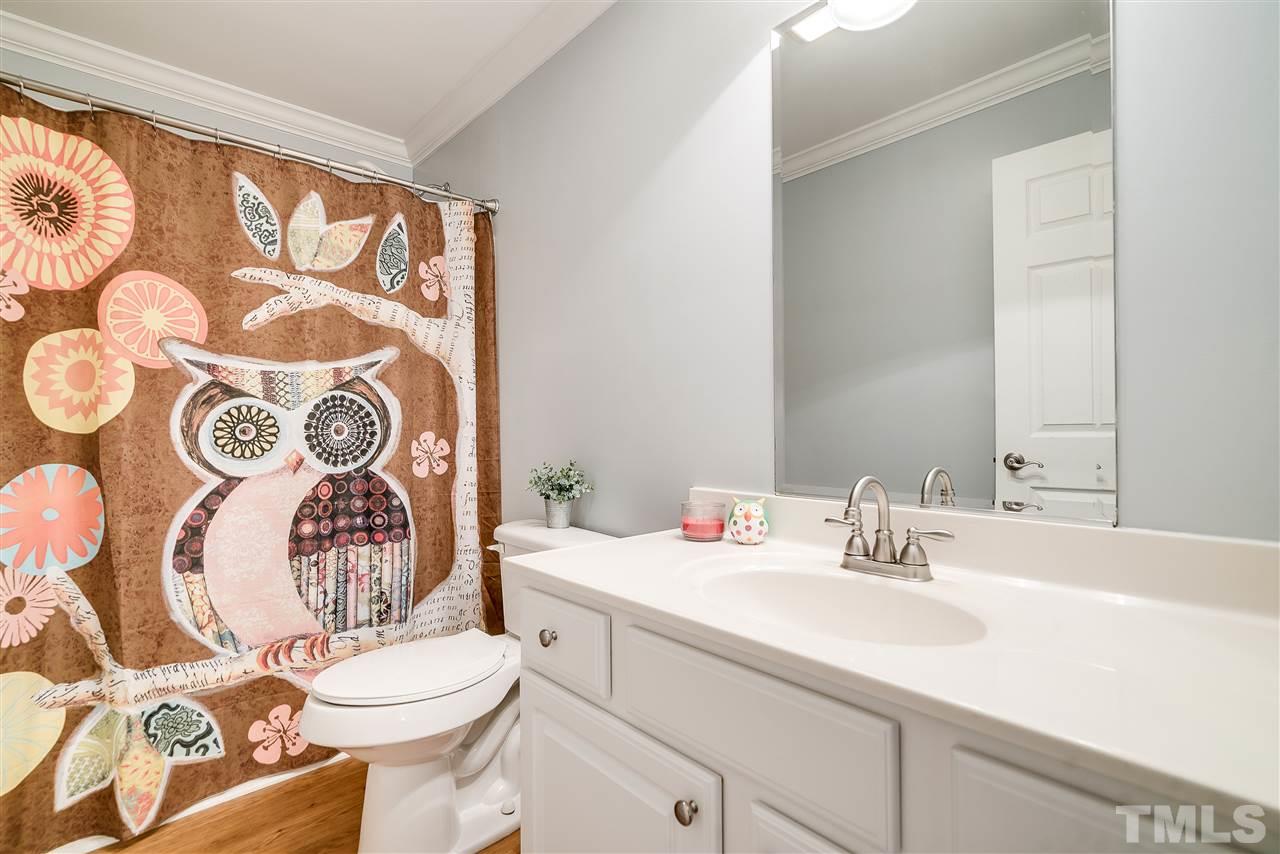 6008 East Pool Road Rougemont, NC 27572 - Photo 18 of 25 a bathroom with a sink mirror vanity and toilet