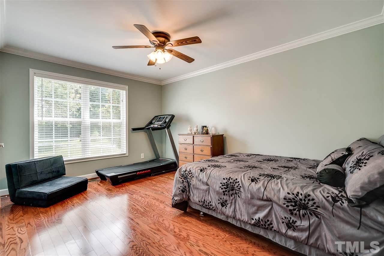 6008 East Pool Road Rougemont, NC 27572 - Photo 19 of 25 a bedroom with a bed and wooden floor