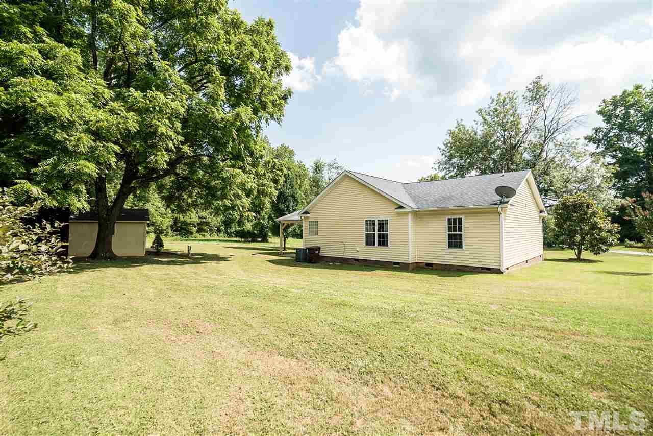 6008 East Pool Road Rougemont, NC 27572 - Photo 22 of 25 a front view of house with yard and trees in the background