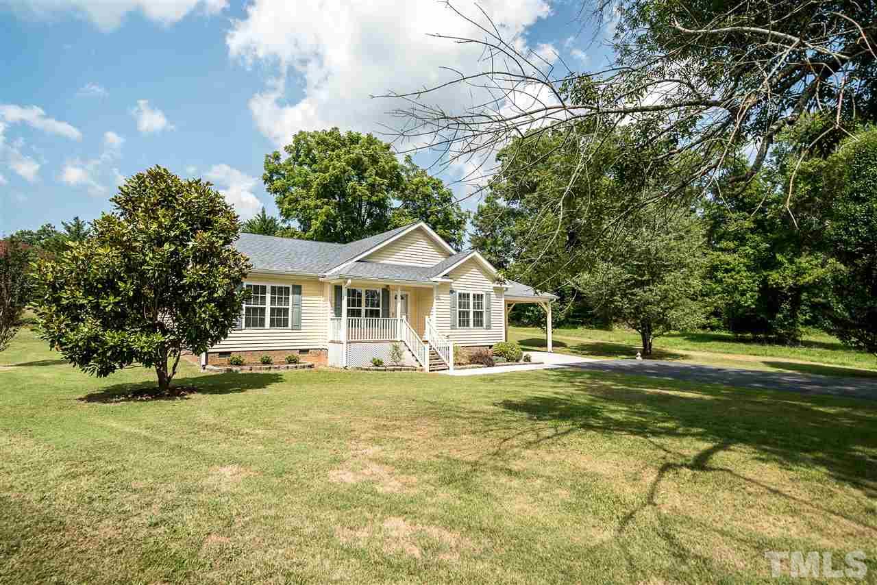 6008 East Pool Road Rougemont, NC 27572 - Photo 25 of 25 a white house that has a tree in it