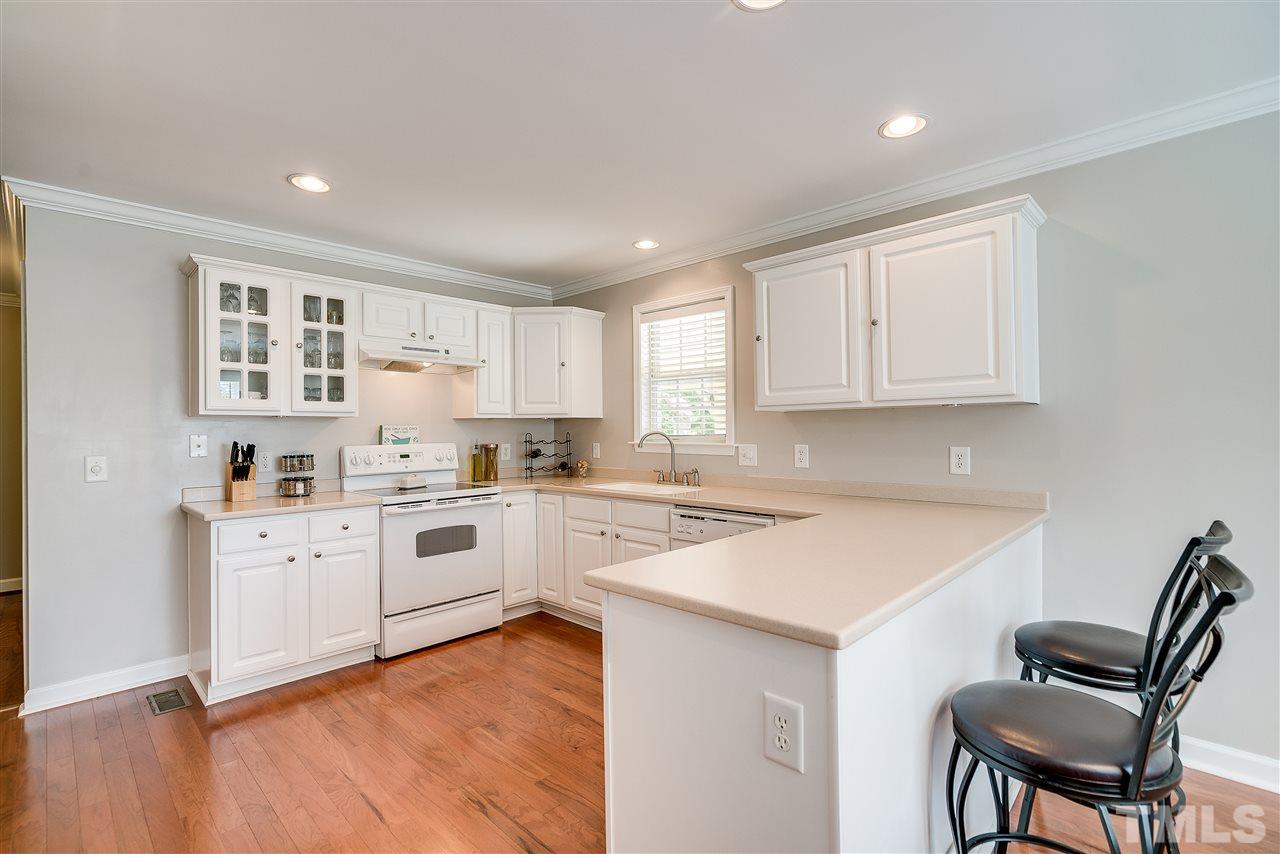 6008 East Pool Road Rougemont, NC 27572 - Photo 9 of 25 a kitchen with white cabinets and white appliances