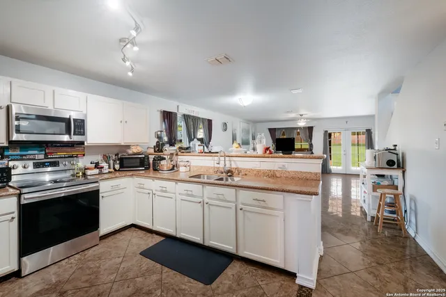 a kitchen with lots of counter top space and appliances