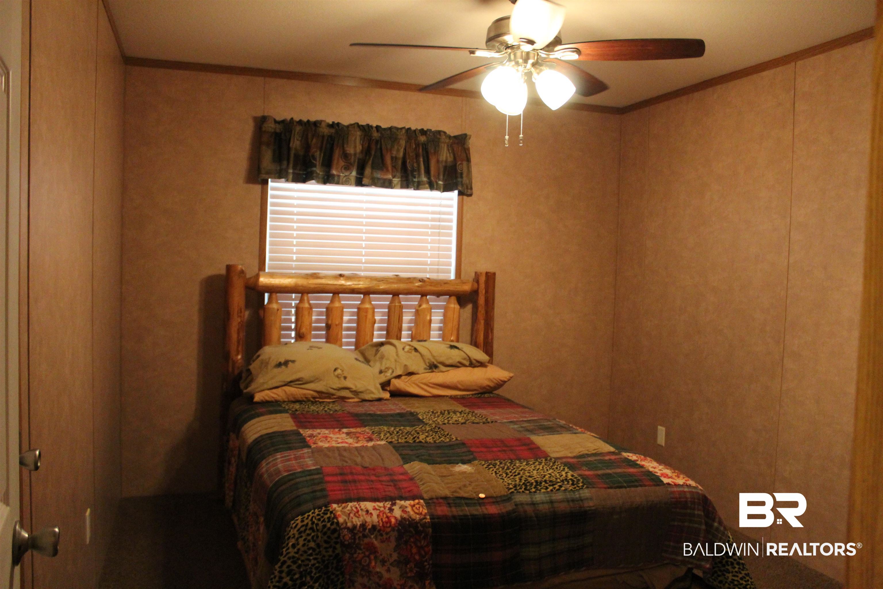 7258 Henderson Road Lowndesboro, AL 36752 - Photo 18 of 22 Bedroom featuring crown molding and ceiling fan