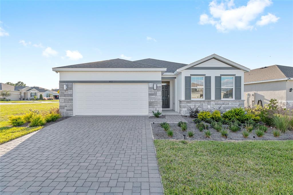 3972 Northwest 48th Terrace Ocala, FL 34482 - Photo 1 of 63 a front view of a house with garden