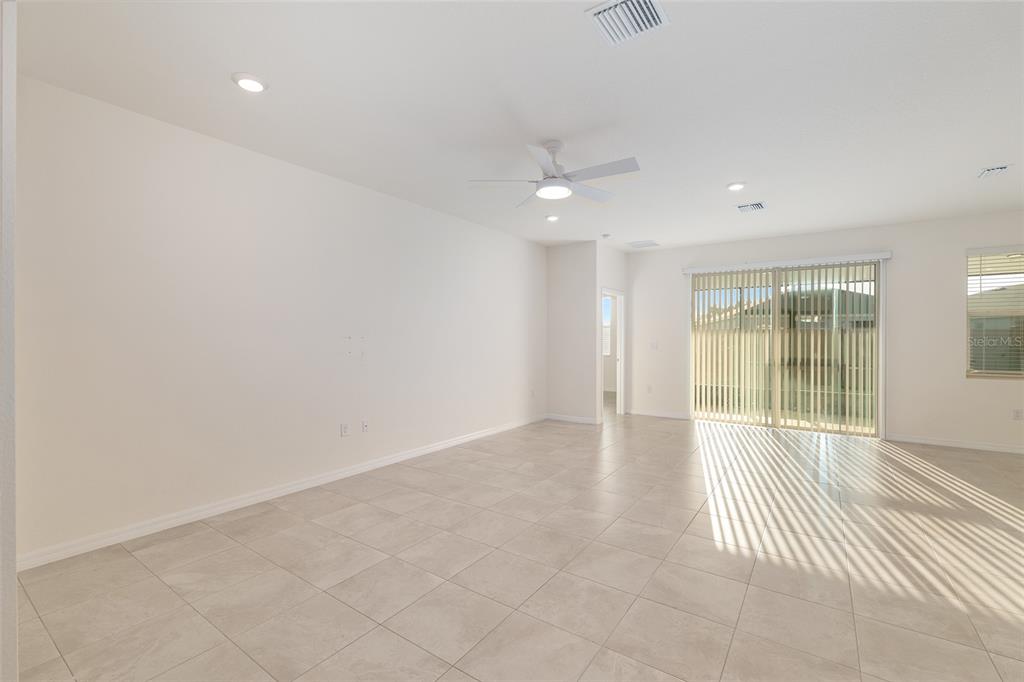3972 Northwest 48th Terrace Ocala, FL 34482 - Photo 12 of 63 an empty room with wooden floor and windows