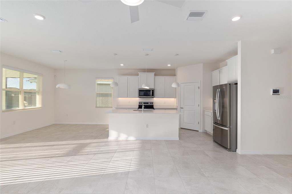 3972 Northwest 48th Terrace Ocala, FL 34482 - Photo 16 of 63 a living room with stainless steel appliances kitchen island granite countertop a refrigerator and a sink