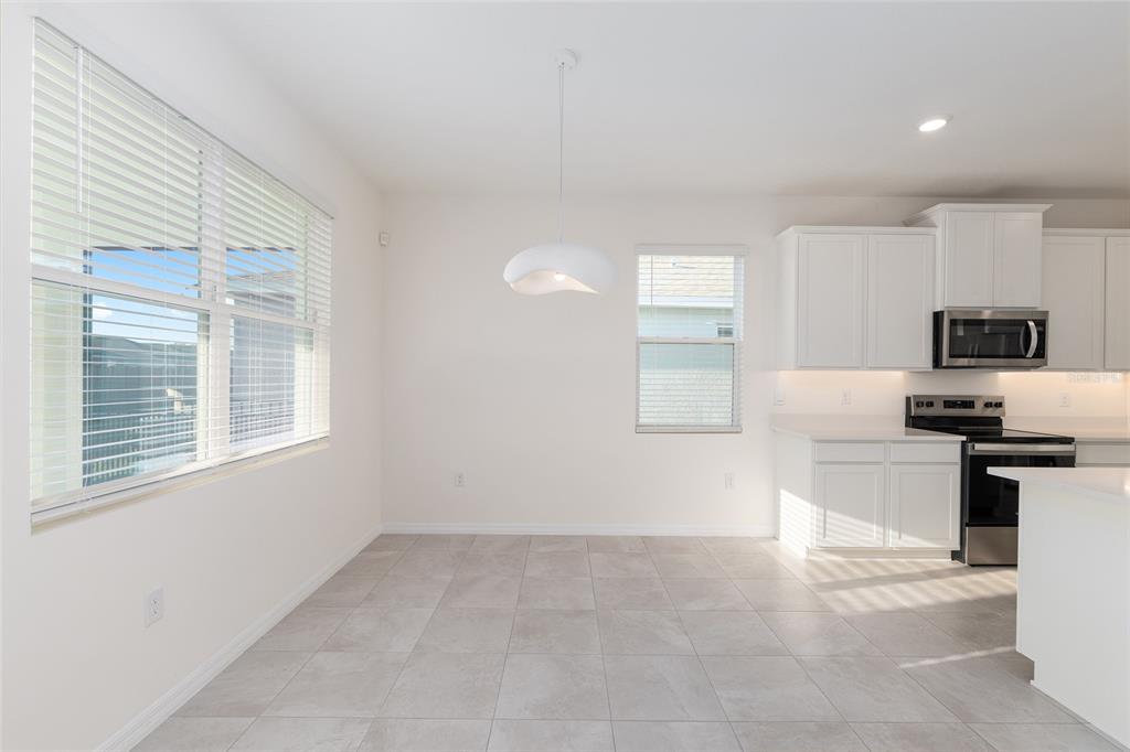 3972 Northwest 48th Terrace Ocala, FL 34482 - Photo 20 of 63 a kitchen with a refrigerator and a stove top oven