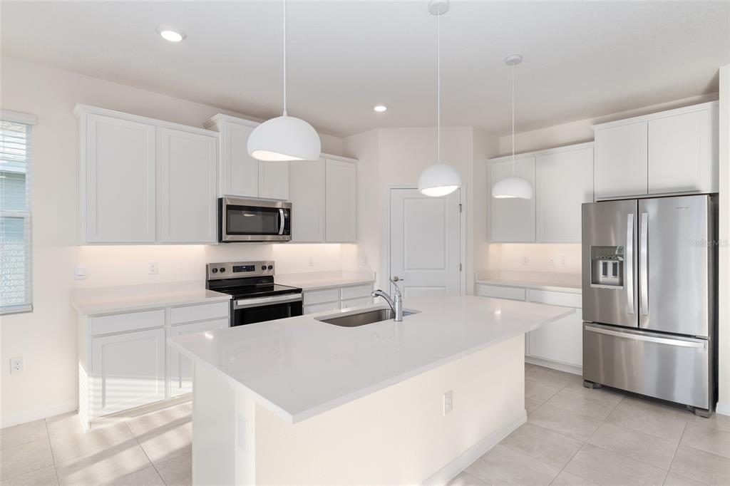 3972 Northwest 48th Terrace Ocala, FL 34482 - Photo 22 of 63 a kitchen with stainless steel appliances a refrigerator a stove a sink and a refrigerator