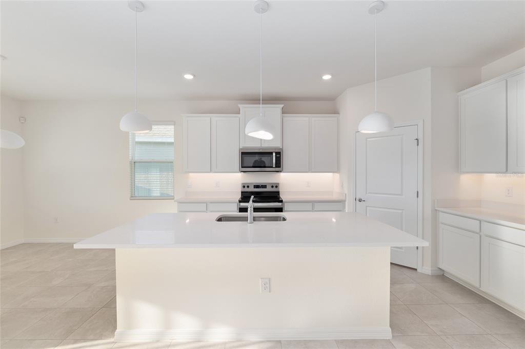 3972 Northwest 48th Terrace Ocala, FL 34482 - Photo 24 of 63 a large kitchen with stainless steel appliances