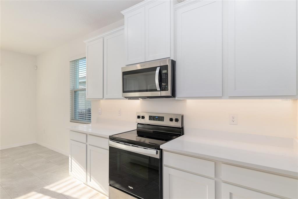 3972 Northwest 48th Terrace Ocala, FL 34482 - Photo 25 of 63 a kitchen with a stove and a microwave