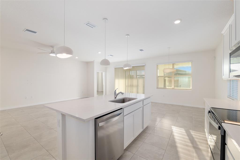3972 Northwest 48th Terrace Ocala, FL 34482 - Photo 26 of 63 a kitchen with stainless steel appliances granite countertop a sink a counter space and a window