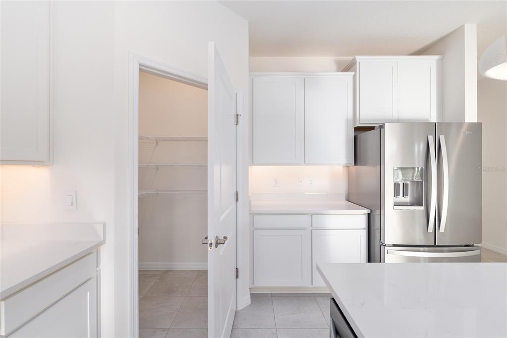 3972 Northwest 48th Terrace Ocala, FL 34482 - Photo 27 of 63 a kitchen with a refrigerator sink and cabinets