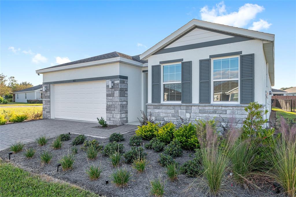 3972 Northwest 48th Terrace Ocala, FL 34482 - Photo 3 of 63 a front view of a house with garden