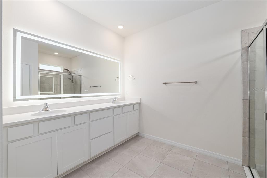 3972 Northwest 48th Terrace Ocala, FL 34482 - Photo 34 of 63 a bathroom with a double vanity sink and mirror