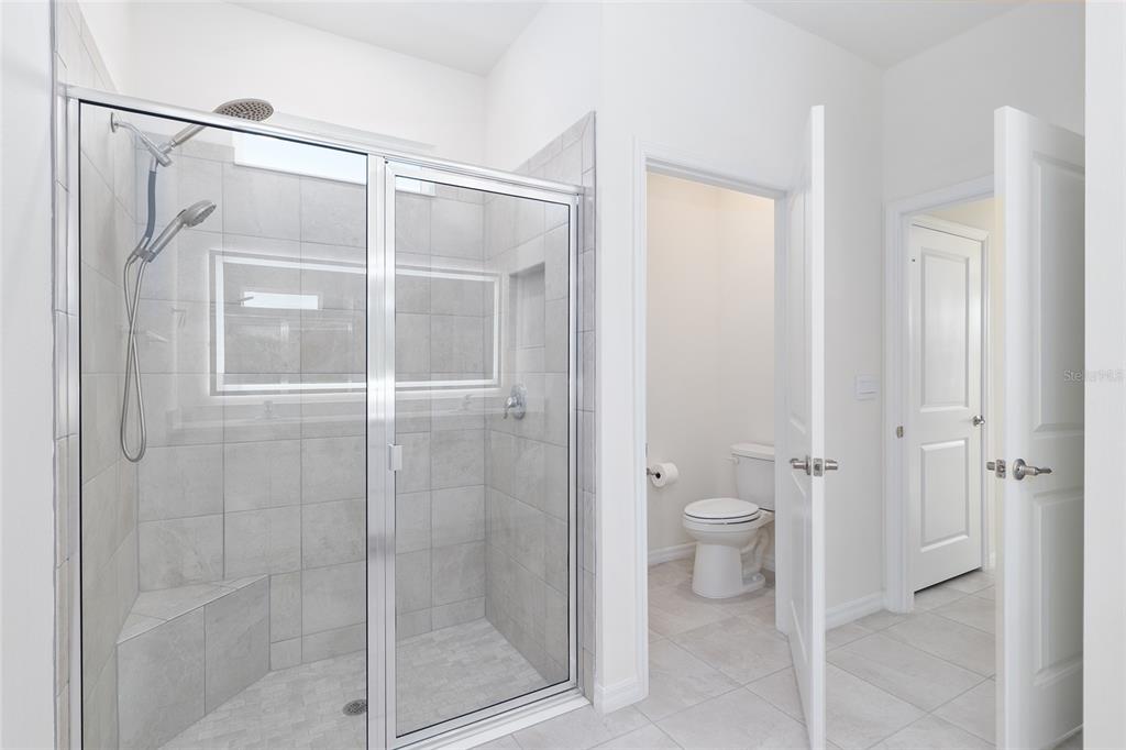 3972 Northwest 48th Terrace Ocala, FL 34482 - Photo 37 of 63 a bathroom that has a glass shower door