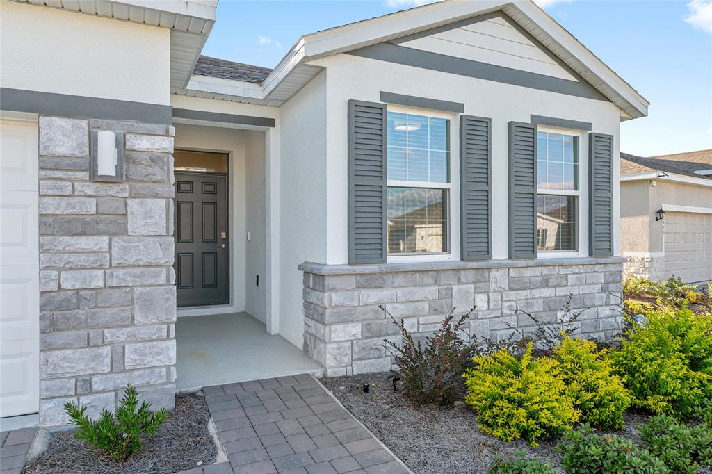 3972 Northwest 48th Terrace Ocala, FL 34482 - Photo 6 of 63 a front view of a house with a garden