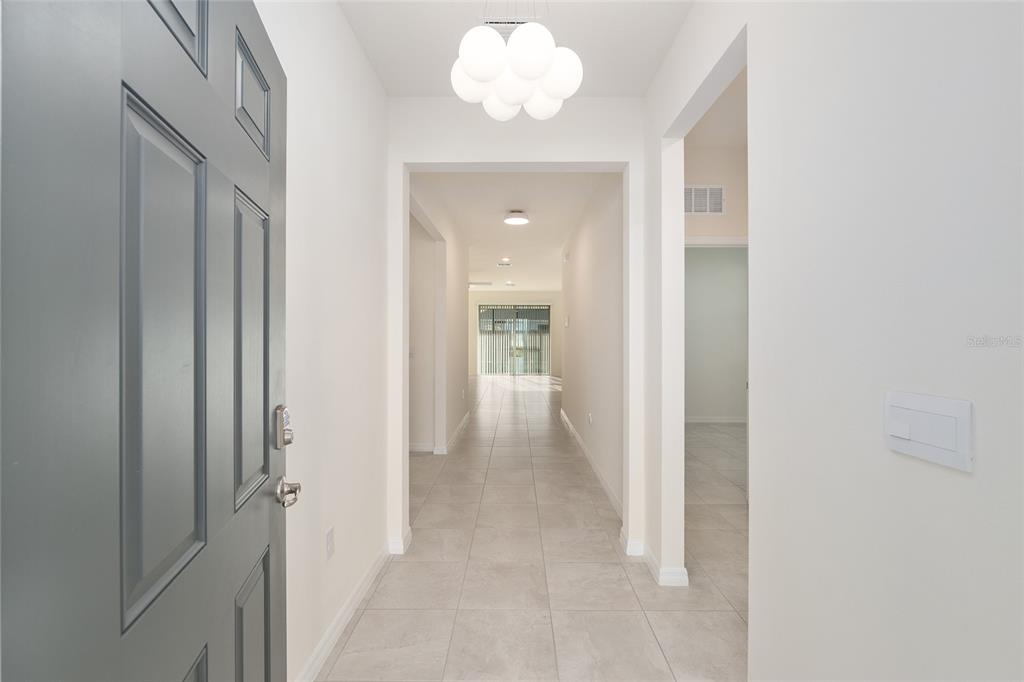 3972 Northwest 48th Terrace Ocala, FL 34482 - Photo 10 of 63 a view of a hallway with a chandelier