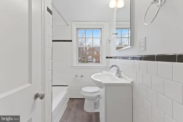 a bathroom with a sink toilet and a mirror