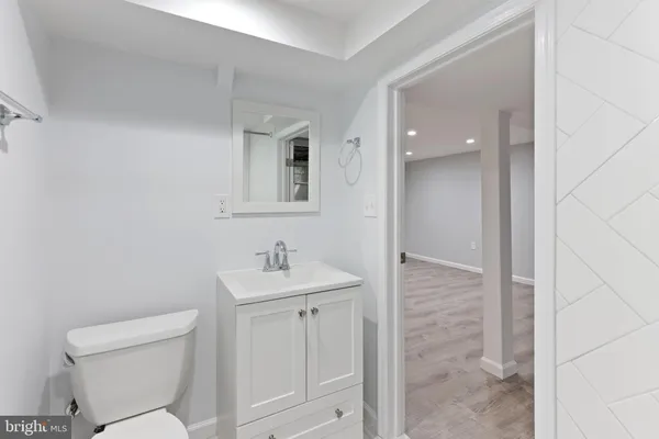 a bathroom with a toilet a sink and mirror