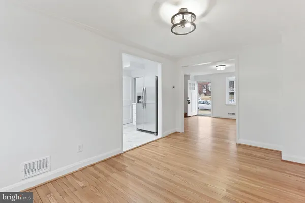 a view of a room with wooden floor and windows
