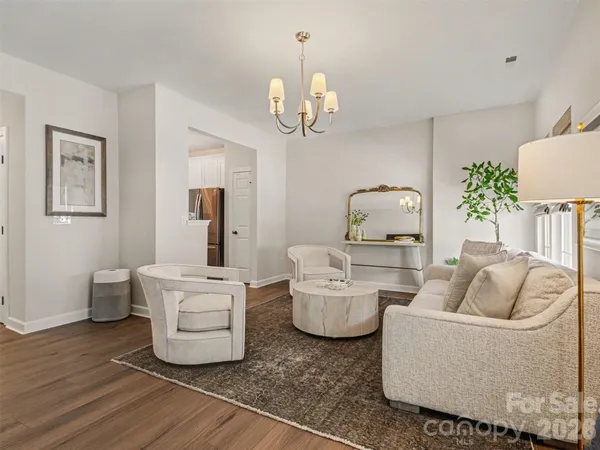 a living room with furniture a chandelier and a couch